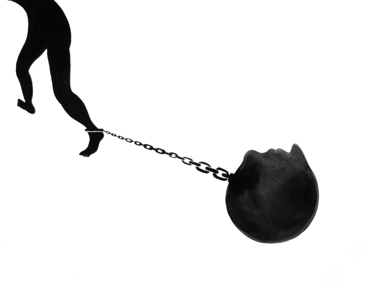 Black silhouette of a running figure's legs, ankle shackled by a chain to a heavy round ball.