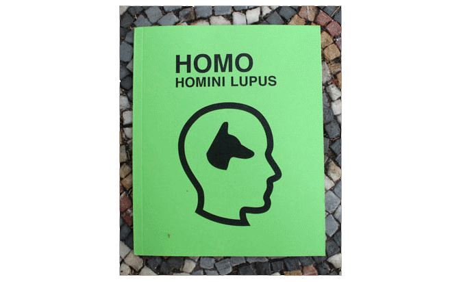 Green booklet cover titled "HOMO HOMINI LUPUS" with a black outline of a human head profile containing a wolf's head silhouette inside it.