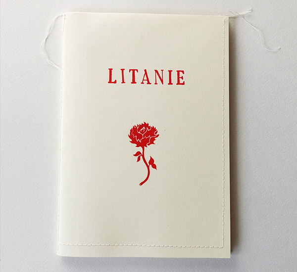 White stitched-binding booklet cover with the title "LITANIE" in red text and a red line illustration of a thorny rose below it.