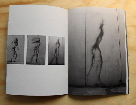 Open booklet spread with three small sequential photos of a running silhouette figure on a wall on the left page, and one larger photo of the same dark silhouette figure stretched vertically on a paneled concrete wall on the right.