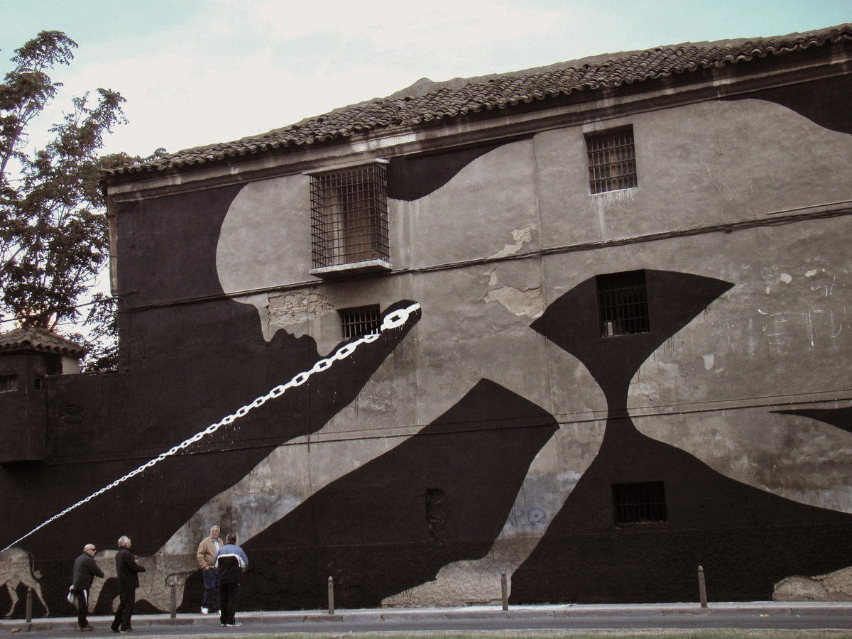 Black silhouette of a bent figure with a long chain leash trailing from its mouth down to a small donkey at the bottom of a building wall, dark negative space forming an hourglass shape between two barred windows, people standing on the street below.