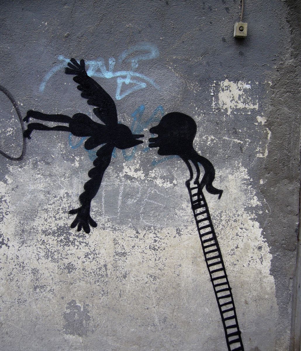 Black silhouette of a winged bird-woman figure with dangling human legs facing a profile head atop a tall ladder, mouths almost touching, blue graffiti scribbles above, a doorbell mounted on the wall.