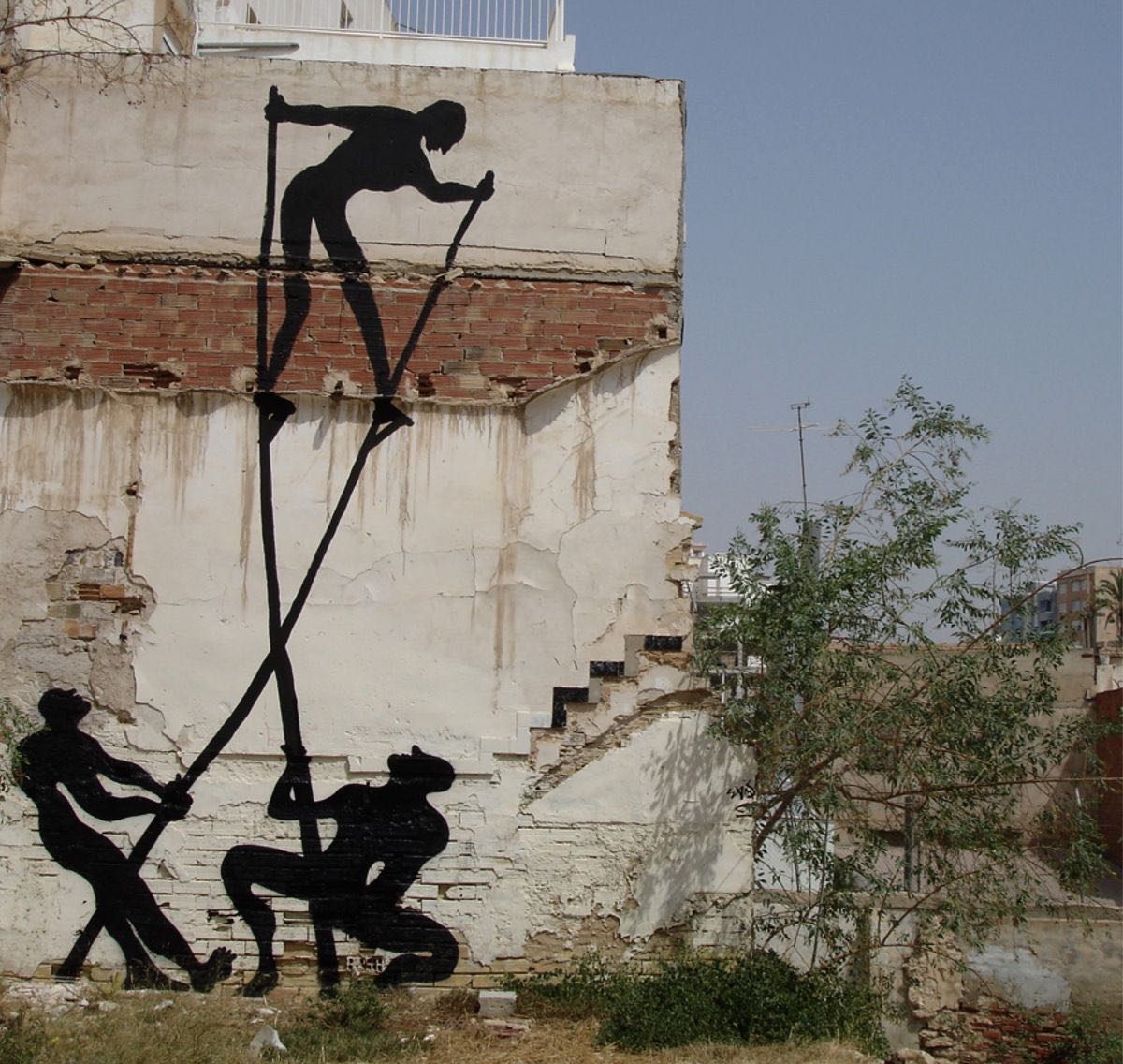 Black silhouette of a large round shape resembling a mosquito or head painted on a rolled-down metal shutter, connected to a bent walking figure covering its face, a child and a woman standing on the sidewalk nearby.